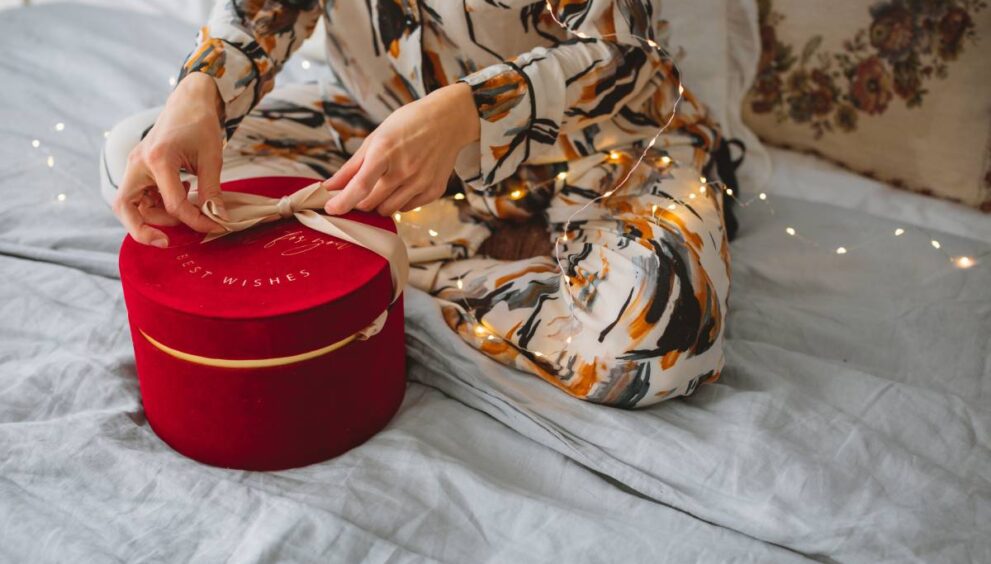 girl-in-beautiful-pajamas-opening-a-gift-early-on-2025-01-08-06-43-27-utc (1)