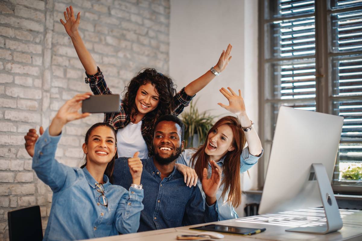 Group of young people doing selfie in the office